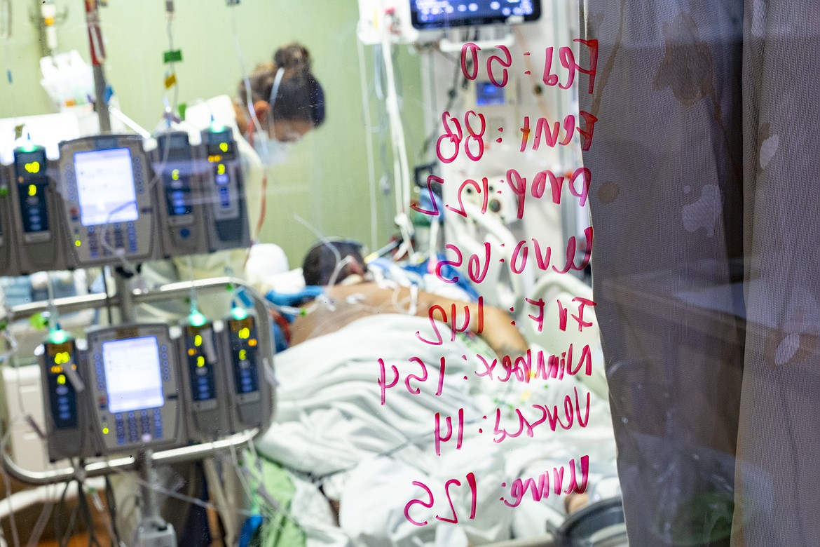 FILE - In this Aug. 31, 2021, file photo, Ann Enderle R.N. checks on a COVID-19 patient in the Medical Intensive care unit (MICU) at St. Luke's Boise Medical Center in Boise, Idaho. Idaho public health leaders have activated "crisis standards of care" for the state's northern hospitals because there are more coronavirus patients than the institutions can handle. The Idaho Department of Health and Welfare made the announcement Tuesday, Sept. 7. (AP Photo/Kyle Green, File)