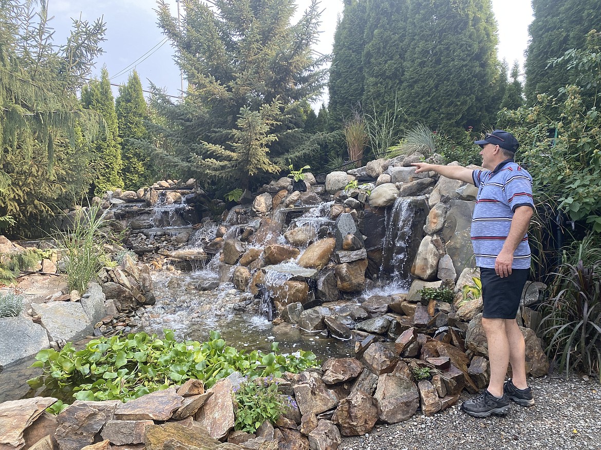 Roosevelt Inn owner John Hough looks over his handiwork, an extravagant waterfall feature that Hough designed and built with 22 tons of rock placed by hand.