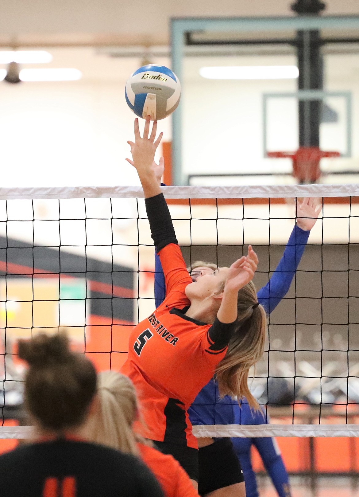 Priest River's Helena White attempts to tip the ball over the net during Thursday's match against Clark Fork.
