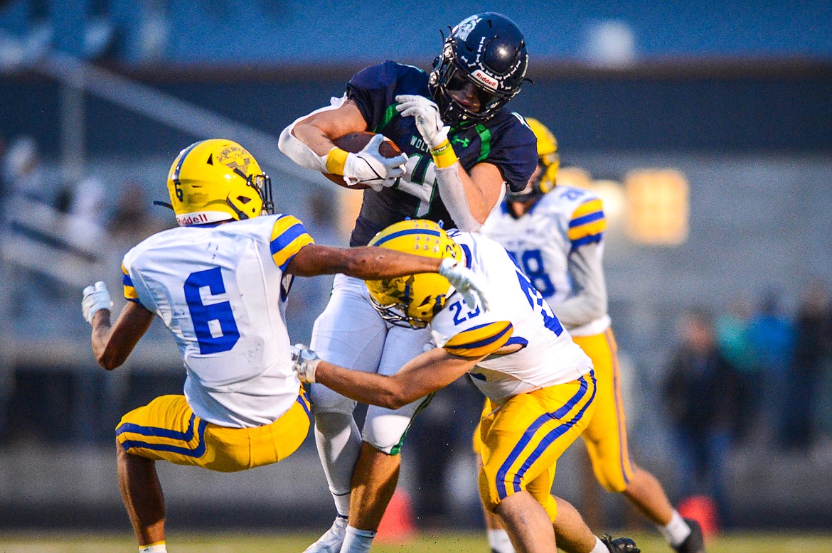 Glacier tight end Luke Bilau (4) breaks a pair of tackles by Missoula Big Sky defenders Louis Sanders (6) and Dallas Wells (23) on a second-quarter reception at Legends Stadium on Friday, Sept. 10. (Casey Kreider/Daily Inter Lake)