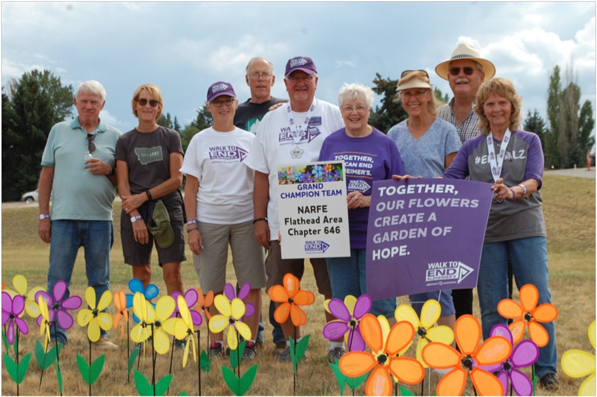 Members of the Flathead Area Chapter 0646 of the National Active and Retired Federal Employees Walk to End Alzheimer's team, and all volunteer walkers, carry flowers to raise awareness about Alzheimer's disease. - photo by Kent Meireis