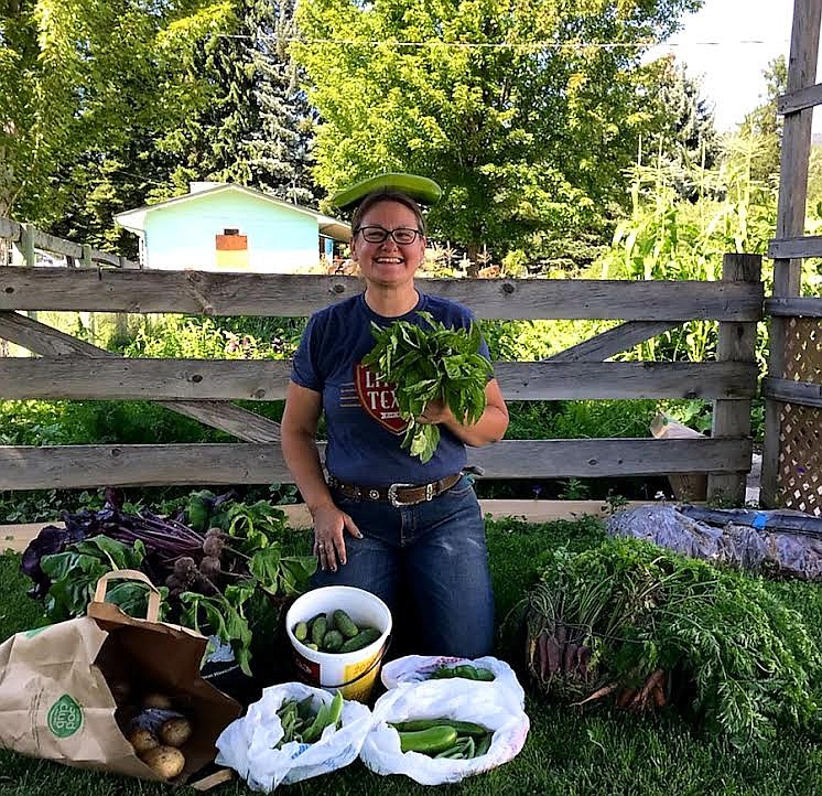 Naomi Messenbrink balances a zucchini on her head and displays a beautiful array of produce harvested from the garden at the St. Regis Community Church. (Photo courtesy Naomi Messenbrink)