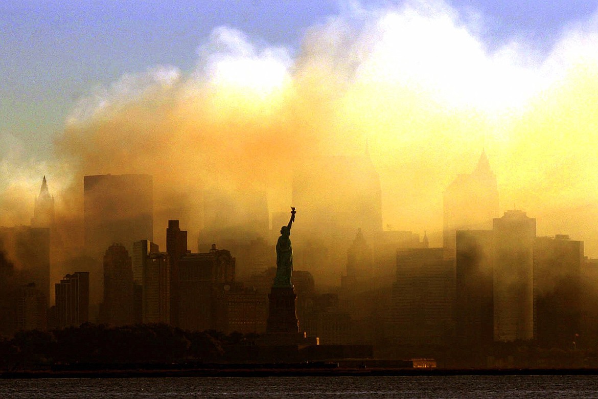 In this Sept. 15, 2001, file photo, the Statue of Liberty stands in front of a smoldering lower Manhattan at dawn, seen from Jersey City, N.J. The Sept. 11, 2001, terrorist attacks on the United States nearly 20 years ago precipitated profound changes in America and the world. (Dan Loh/Associated Press)