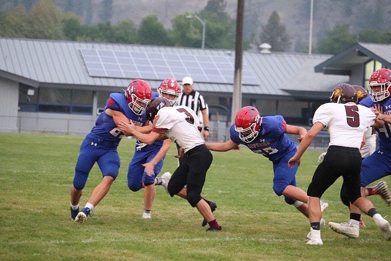 The Superior Bobcats gang tackle the Troy quarterback during last Friday’s game. (Photo courtesy Kami Millender)