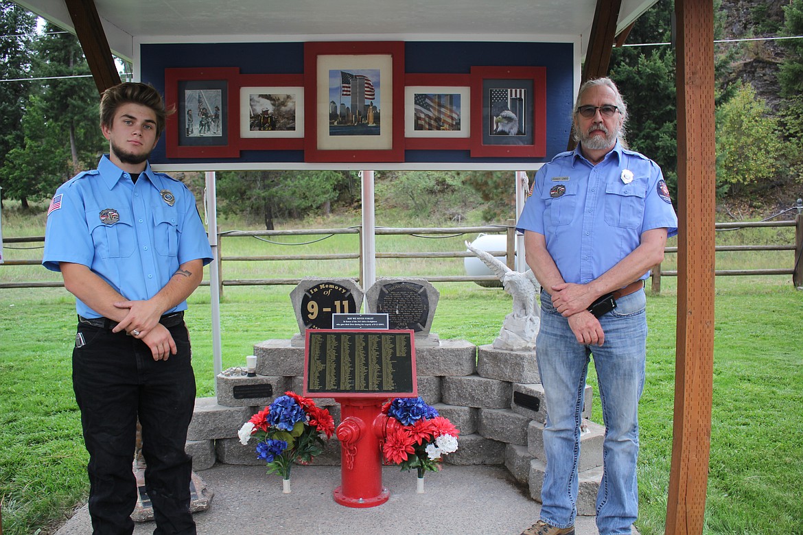 Thompson Falls Rural Fire Department members Nathaniel Liam Moore, left, and Randy Umbs help display the 9/11 Memorial at last Saturday’s ceremony commemorating the 20th anniversary of the terrorist attacks on the United States. (Monte Turner/Valley Press)