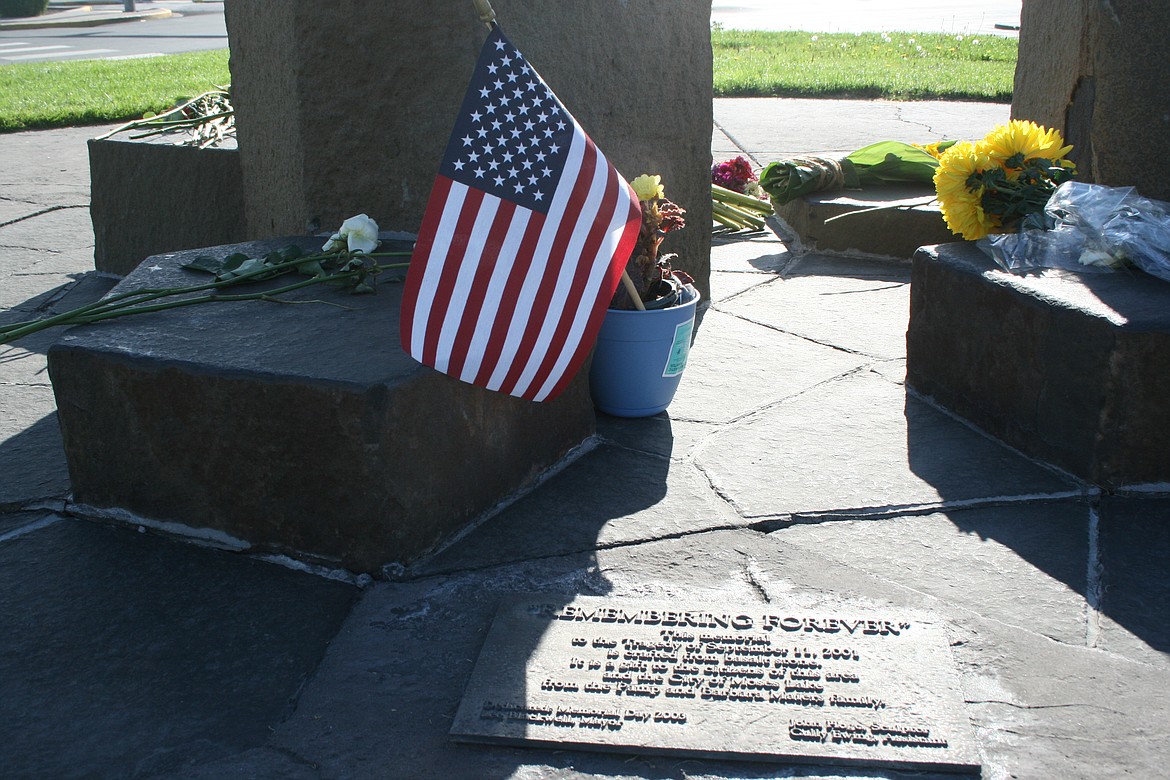 An American flag and flowers sit at the Moses Lake 9/11 memorial Saturday, the 20th anniversary of the attacks.