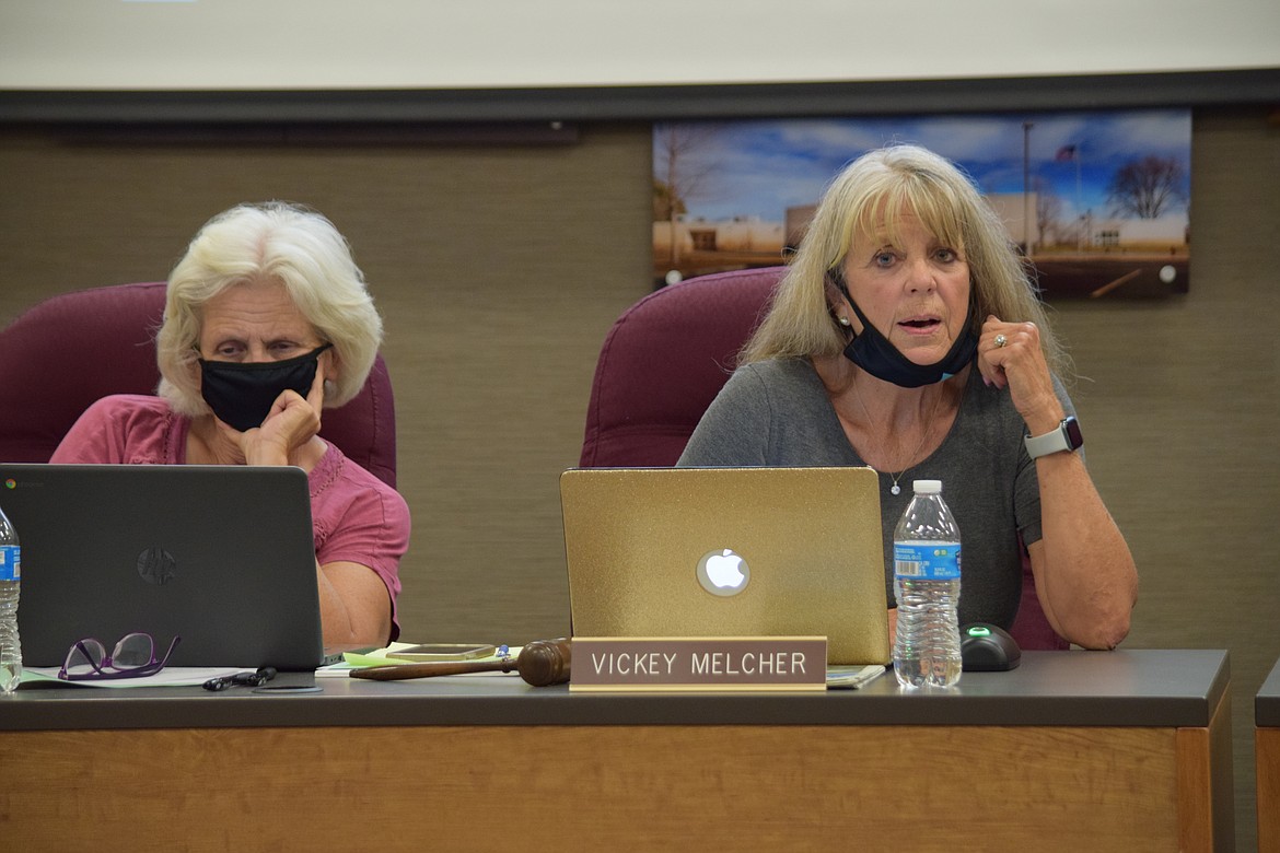 Moses Lake School Board Vice President Susan Freeman (left) and president Vickey Melcher sit at their desk at the beginning of Thursday’s meeting.