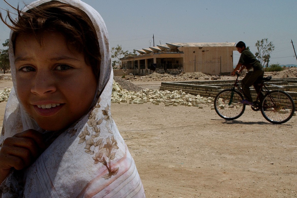 A young boy rides the only bike in Kabani, Iraq, according to Bartholdt while he was embedded with the U.S. military in Iraq in 2004.