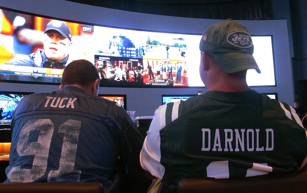 This Sept. 9, 2018, file photo shows fans of the New York Giants and Jets watching a football game after placing bets in the sports betting lounge at the Ocean Casino Resort in Atlantic City, N.J. The American Gaming Association projects that 45.2 million Americans will bet on the NFL this season. (Wayne Parry/Associated Press)