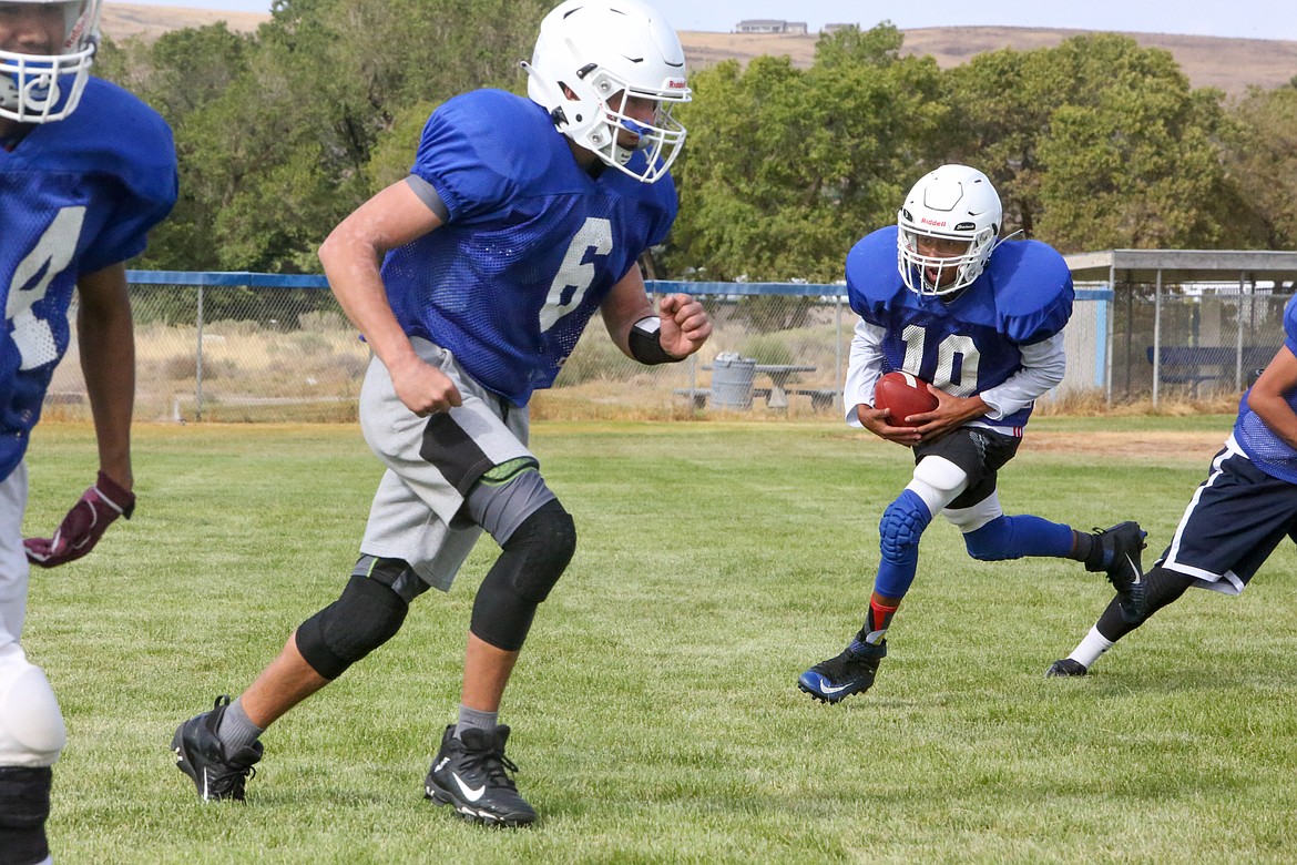 CJ Balderas, No. 10,  takes the ball out of the backfield with Pavlo Stoyan, No. 6, blocking as the Soap Lake offense runs through some plays Aug. 26.