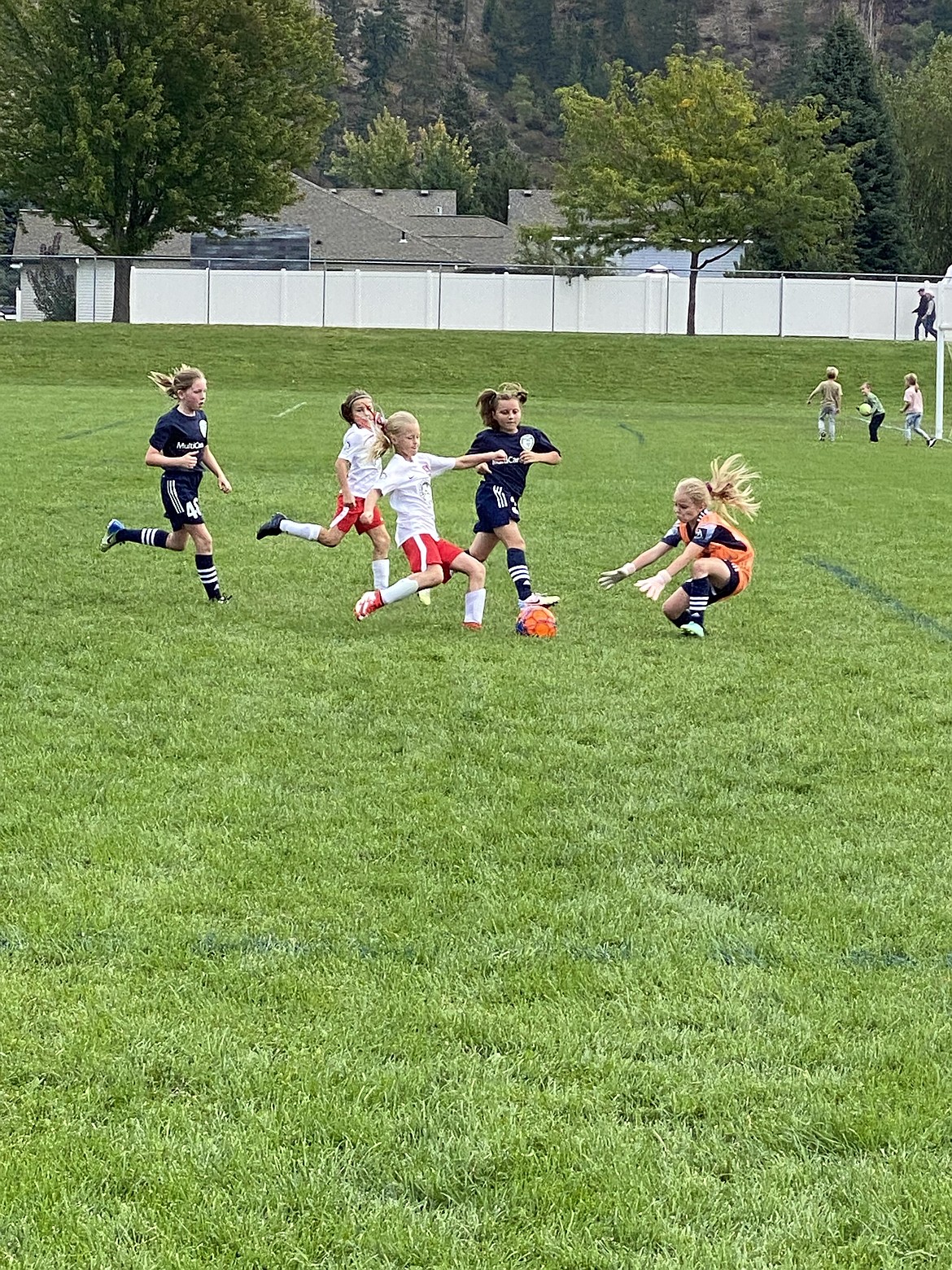 Photo by BRITNEY NUSSER
The Thorns North FC 2011 girls yellow soccer team beat the Spokane Scotties 2-0 at the Dwight Merkel Sports Complex in Spokane on Saturday. Brightyn Gatten and Aubrey Sargent each scored one goal for the Thorns. Pictured in white is Brightyn Gatten closing in on the keeper, with teammate Hailey Viaud to her left.