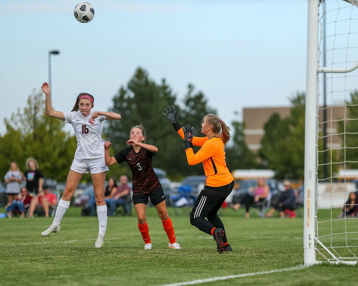 Kylie Williams goes up to score on a header during Tuesday's match at Post Falls.