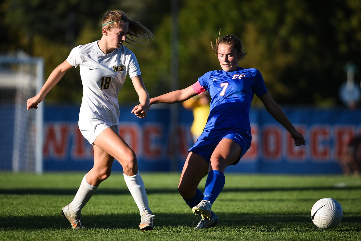 Whitefish's Maeve Ingelfinger (18) pushes the ball past Columbia Falls' Maddie Robison (7) in the second half at Columbia Falls High School on Tuesday, Sept. 14. (Casey Kreider/Daily Inter Lake)