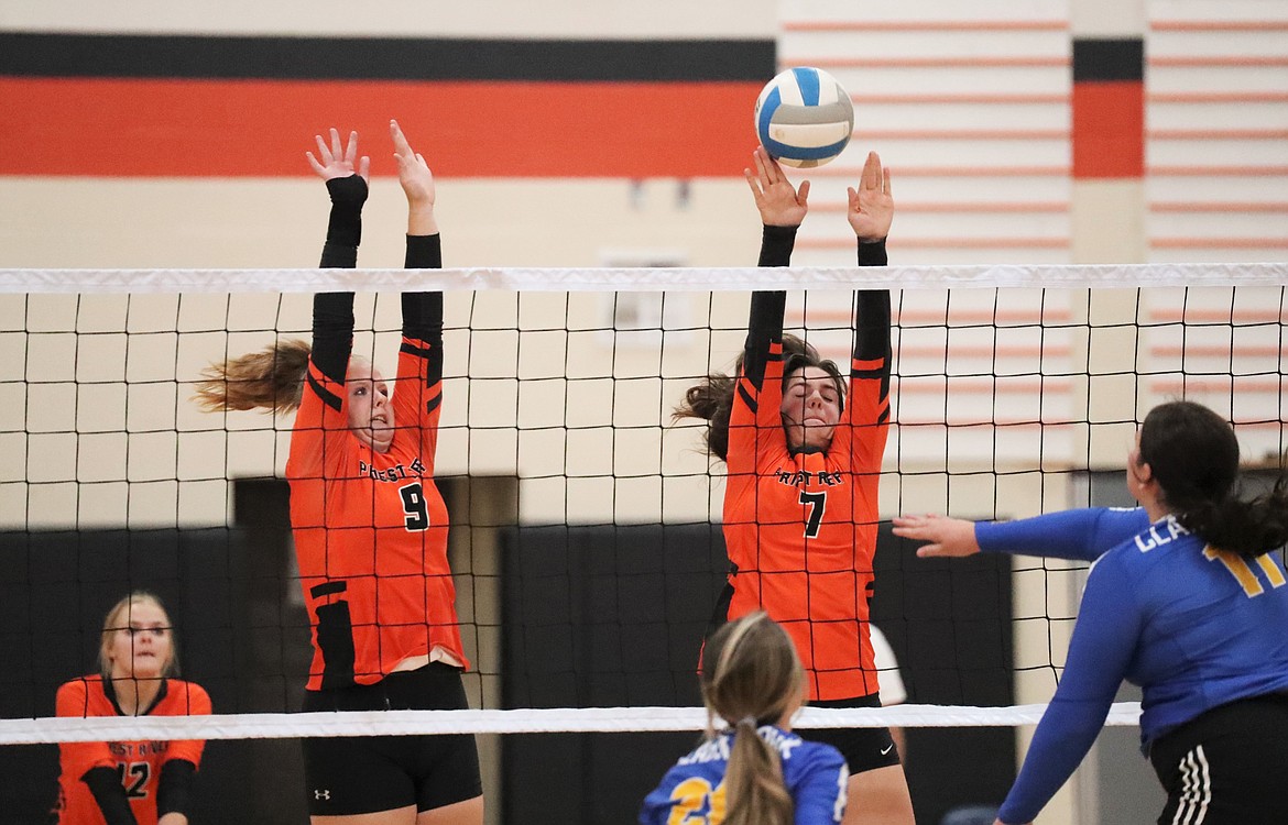 Allyson Barton (left) and Brodie Hansen rise up for a block during Thursday's match against Clark Fork.