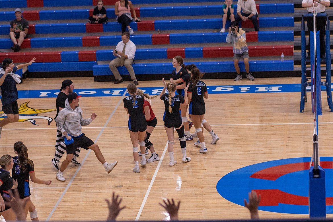 Photo by JERRY VICK
Coeur d'Alene High students rush the court to celebrate with the players after Coeur d'Alene rallied from two sets down to beat Lake City on Tuesday night at Coeur d'Alene High's Viking Court.