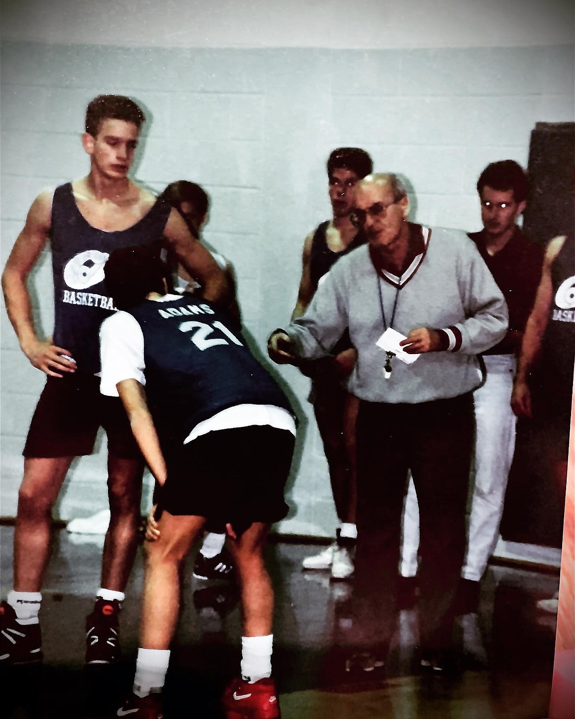 Former Coeur d'Alene High boys basketball coach Don Haynes provides instruction to player Jon Adams, the current Coeur d'Alene boys coach, during a 1991 practice. Haynes, 91, passed away on Tuesday.
