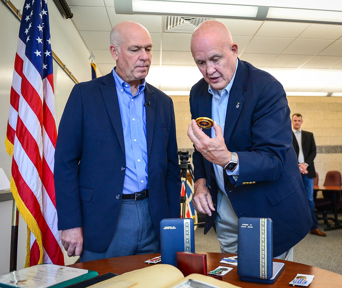 Gov. Greg Gianforte and Mark Mulder look at a Gold Star Gianforte presented to the family of Lt. John “Jack” T. Mulder, a World War II soldier who went missing after a battle in Germany five days after his son’s birth on November 19, 1944. (Casey Kreider/Daily Inter Lake)