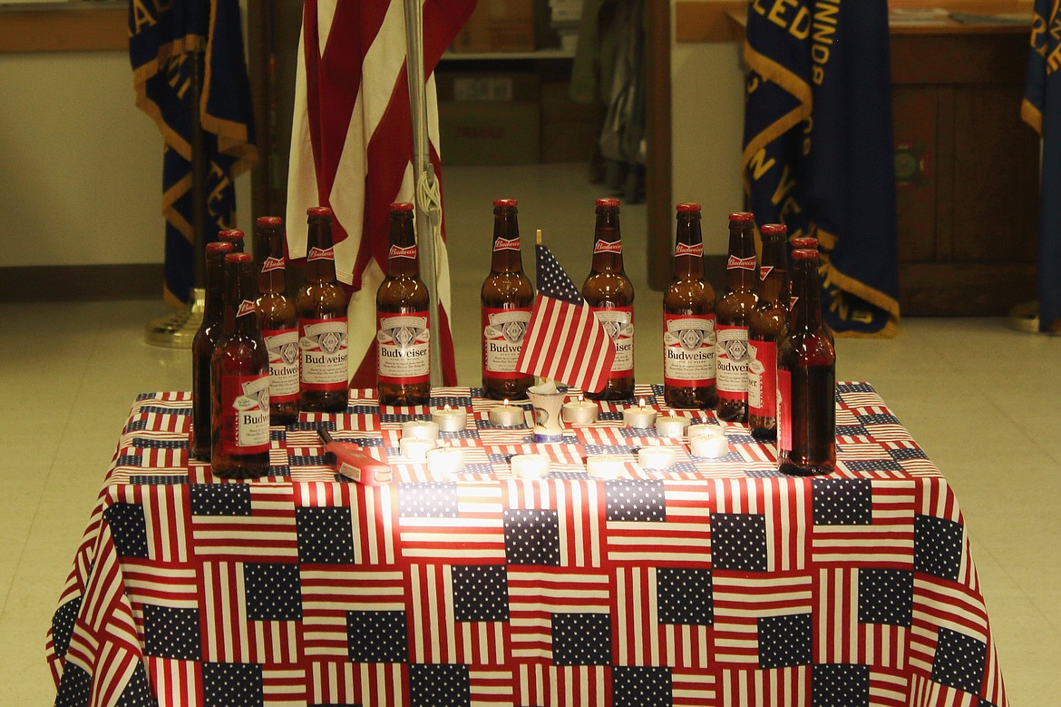 (Photo by Victor Corral Martinez)
Members of the VFW brought one beer to a table in front of the flag, lit a candle, saluted the flag and troop they were honoring, as the names of the fallen were read out loud.