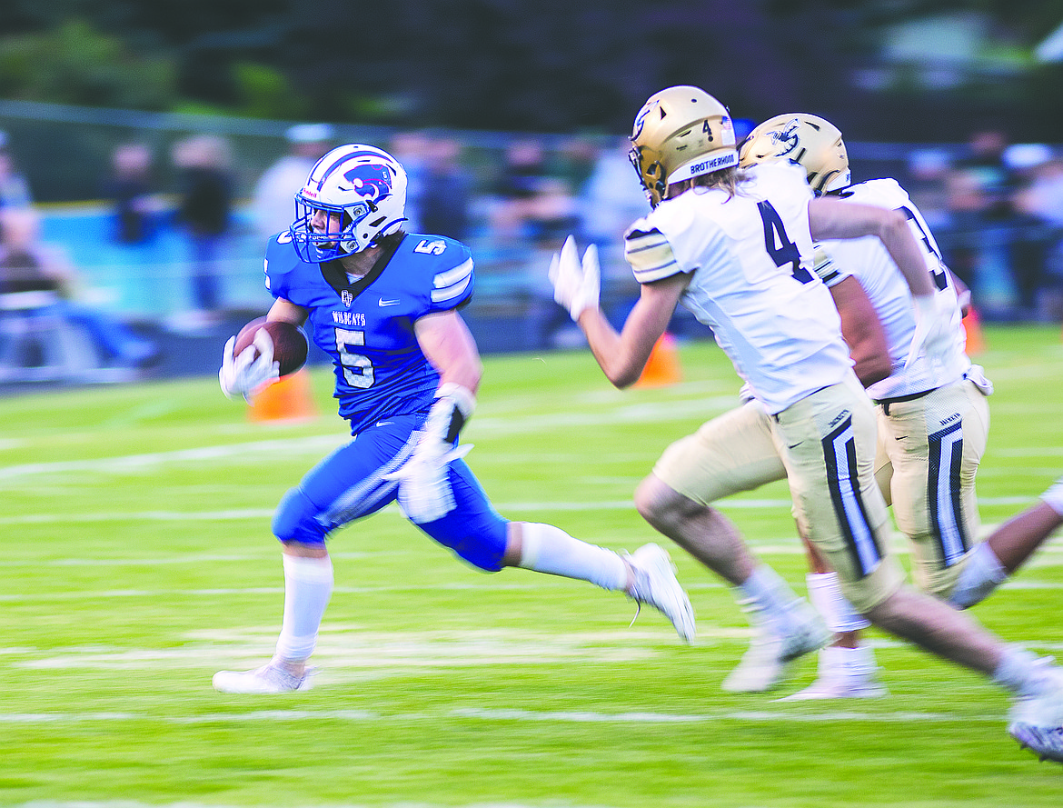 Columbia Falls’ Isaiah Roth (5) runs for yardage against Stevensville on Aug. 27 (Chris Peterson/Hungry Horse News)