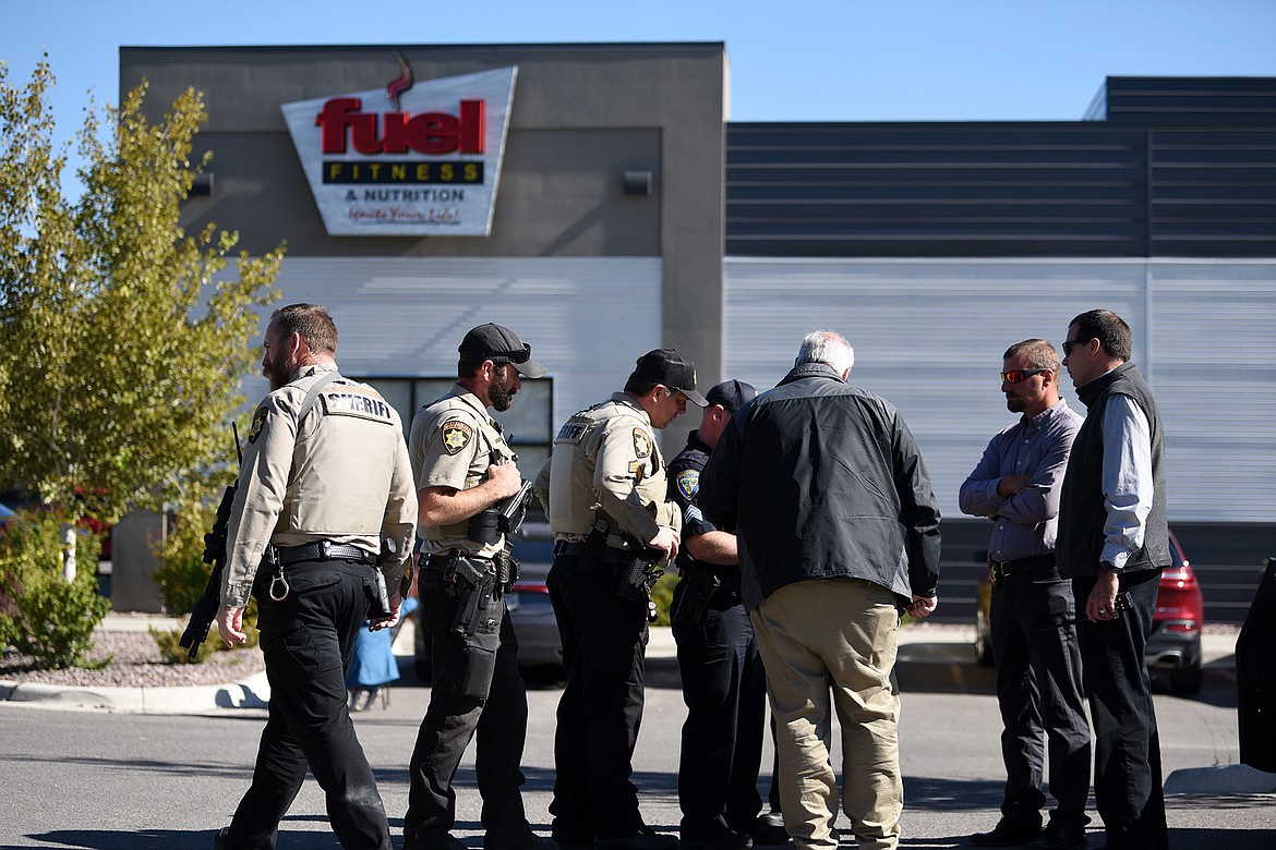 Law enforcement stand at the scene of a shooting outside Fuel Fitness in Kalispell on Thursday, Sept. 16. (Casey Kreider/Daily Inter Lake)
