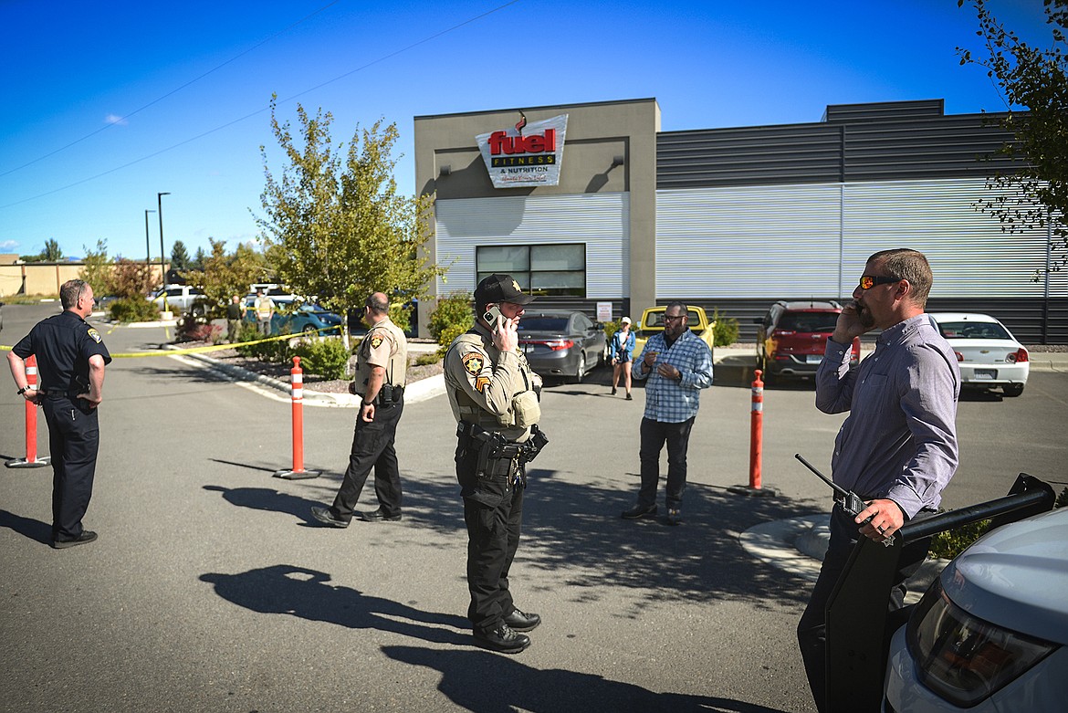 Law enforcement stand at the scene of a shooting outside Fuel Fitness in Kalispell on Thursday, Sept. 16. (Casey Kreider/Daily Inter Lake)
