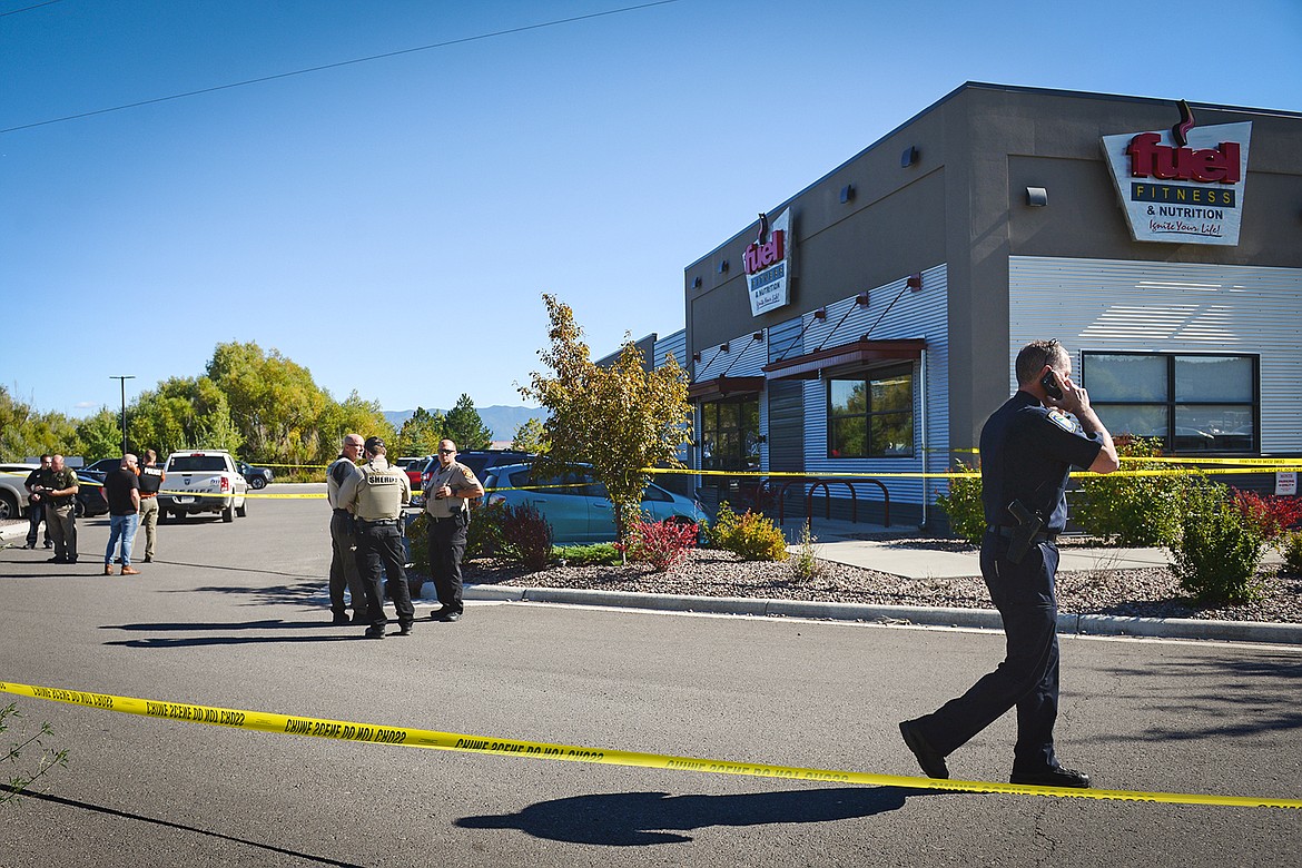 Law enforcement stand at the scene of a shooting outside Fuel Fitness in Kalispell on Thursday, Sept. 16. (Casey Kreider/Daily Inter Lake)