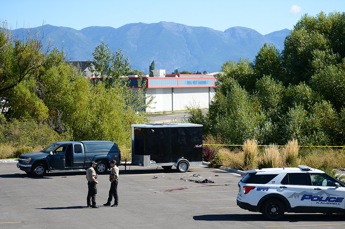 Law enforcement stand at the scene of a shooting outside Fuel Fitness in Kalispell on Thursday, Sept. 16. (Casey Kreider/Daily Inter Lake)