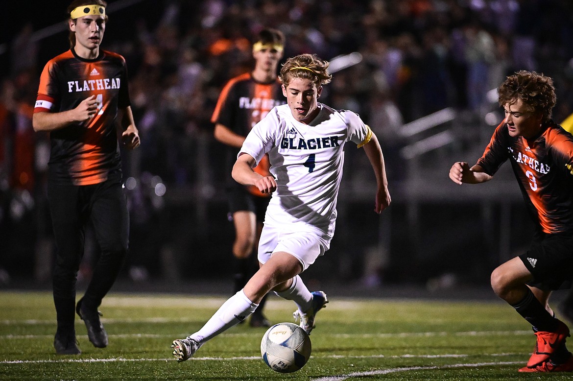 Glacier's Harrison Sanders (4) works between Flathead defenders in the first half at Legends Stadium on Thursday, Sept. 16. (Casey Kreider/Daily Inter Lake)