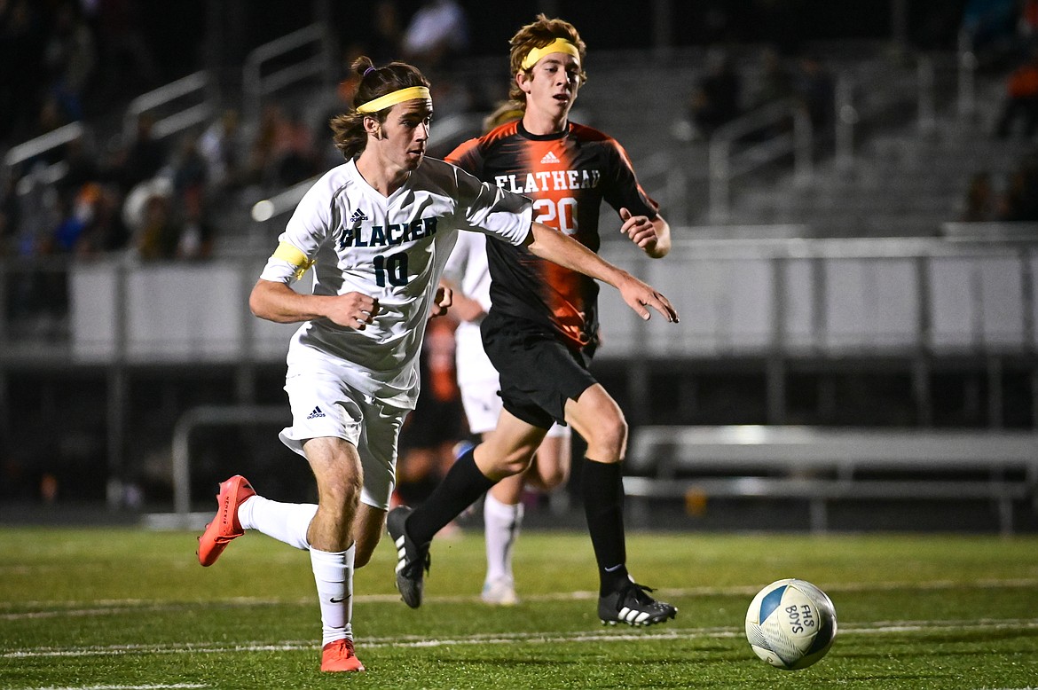 Glacier's Zane Elliott (10) pushes the ball upfield past Flathead's Nick Shelton (20) in the first half at Legends Stadium on Thursday, Sept. 16. (Casey Kreider/Daily Inter Lake)