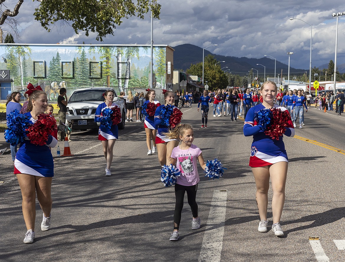 Cheerleaders  march in the parade.