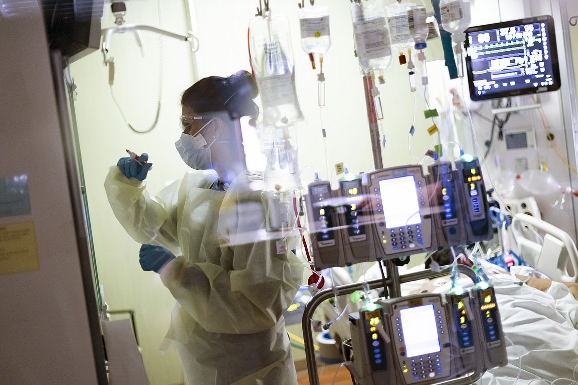 In this Tuesday, Aug. 31, 2021 file photo Ann Enderle R.N. attends to a COVID-19 patient in the Medical Intensive care unit (MICU) at St. Luke's Boise Medical Center in Boise, Idaho. Idaho's public health officials say crisis standards of care are "imminent" for the state's most populated region as hospitals in the Boise area continue to be overrun with unvaccinated coronavirus patients. Hospitals in the northern half of the state were given permission to begin rationing care last week.