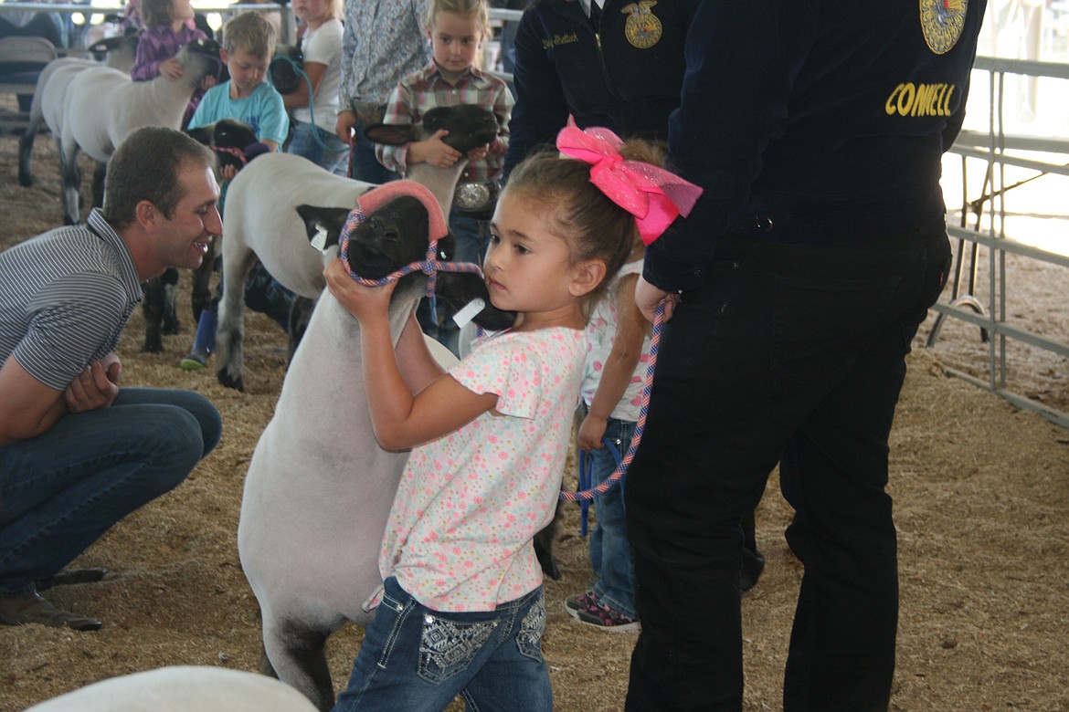 A competitor at the Othello Fair shows off her lamb Thursday.