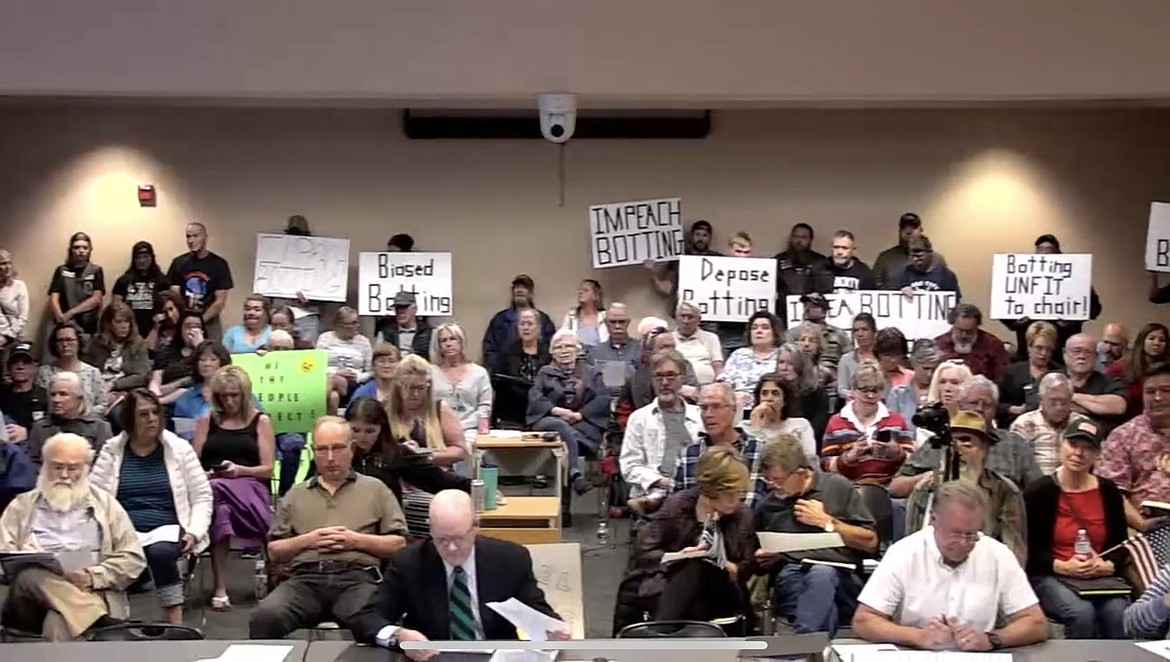 Nearly 100 individuals attended the Optional Forms of Government Study Commission meeting Wednesday night. Some held signs demanding the removal of OFGSC Chair Dave Botting. Photo courtesy Kootenai County.