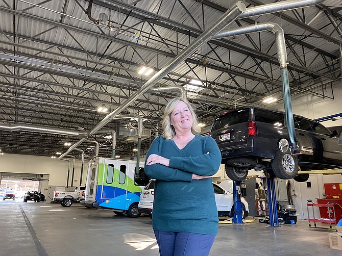 Eve Knudtsen, owner of Knudtsen Chevrolet, stands in front of the service department.