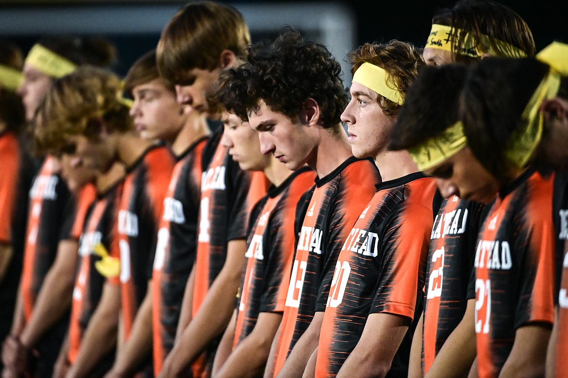 The Flathead boys soccer team has a moment of silence before their game with Glacier in memory of a Glacier student-athlete who took his life last week. Many players from each team wrote messages on their legs or wore ribbons for suicide awareness. (Casey Kreider/Daily Inter Lake)