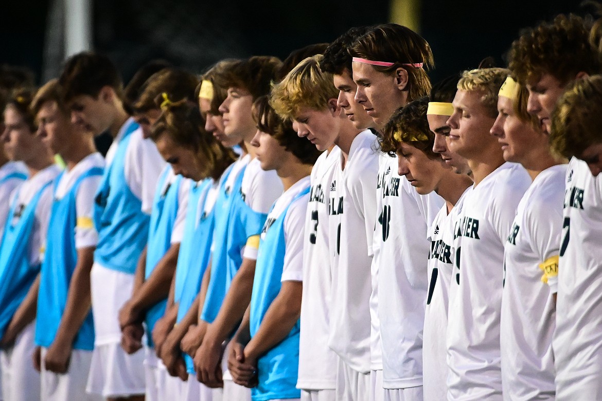 The Glacier boys soccer team has a moment of silence before their game with Flathead in memory of a Glacier student-athlete who took his life last week. Many players from each team wrote messages on their legs or wore ribbons for suicide awareness. (Casey Kreider/Daily Inter Lake)