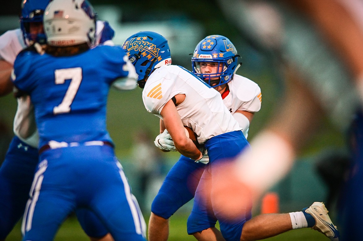 Libby quarterback Ryder Davis (5) hands off to running back Cy Stevenson (6) in the first quarter against Columbia Falls at Satterthwaite Field on Friday, Sept. 17. (Casey Kreider/Daily Inter Lake)