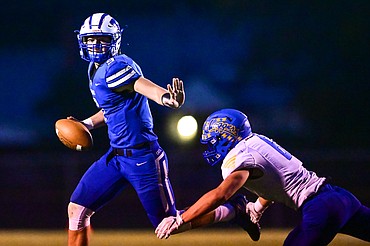 Columbia Falls quarterback Cody Schweikert (9) evades the pass rush by Libby linebacker Cy Stevenson (6) in the second quarter at Satterthwaite Field on Friday, Sept. 17. (Casey Kreider/Daily Inter Lake)