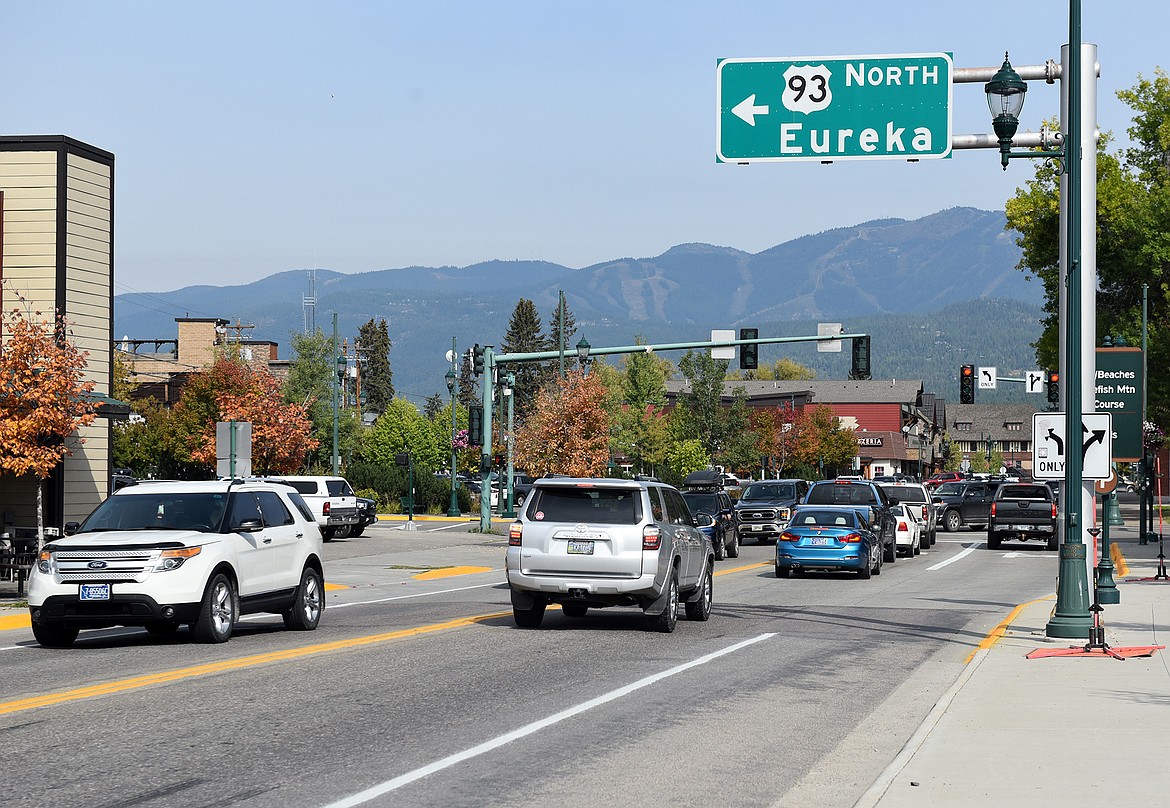 Cars drive along Highway 93 through dowtown Whitefish. (Heidi Desch/Whitefish Pilot)