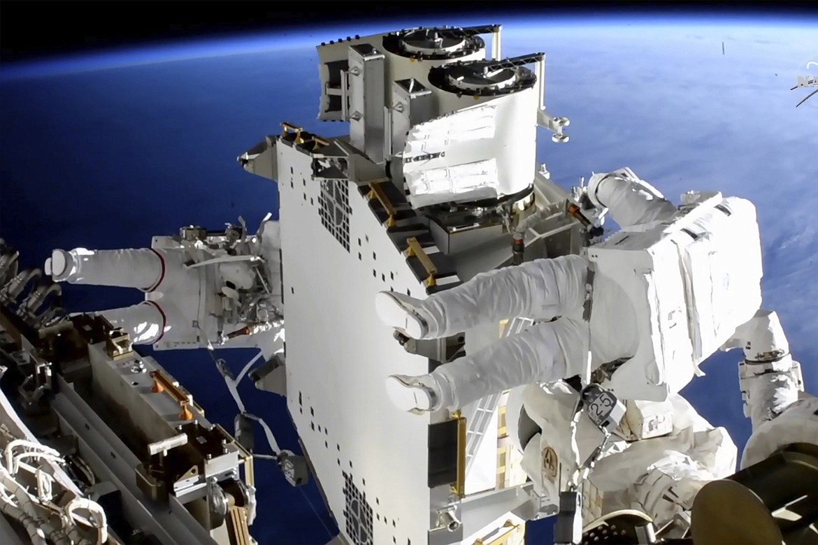 In this image taken from NASA video, French astronaut Thomas Pesquet, left, and NASA astronaut Shane Kimbrough work outside the International Space Station on Sunday, June 20, 2021. (NASA via AP)