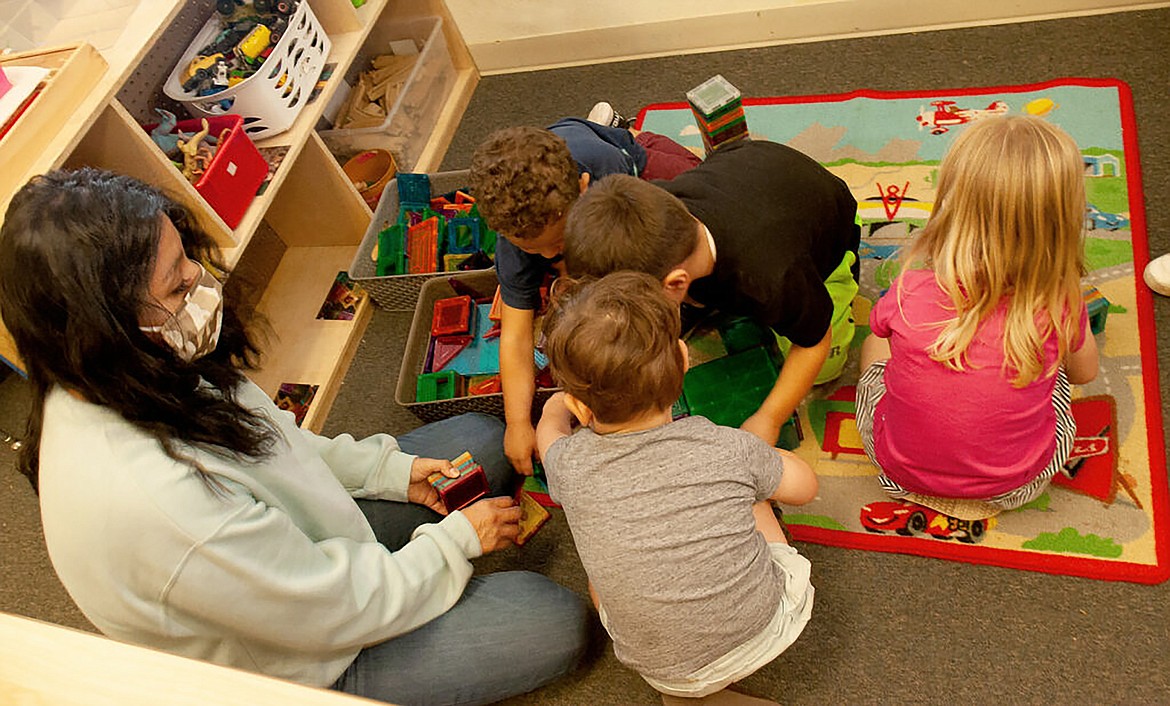 Jackie Galligan, preschool teacher and assistant director at Giraffe Laugh 4 center in Boise, spends some time playing with kids.