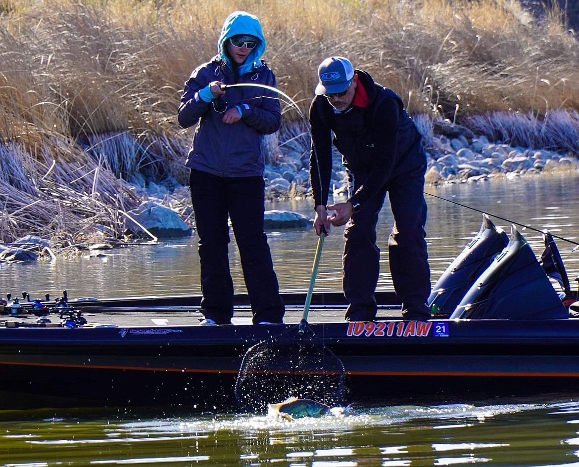 Hannah McCalmant tightly holds her rod while her father, Tony, nets a largemouth bass on Moses Lake. The McCalmants are part of the Idaho Panhandle Bass Anglers Club.