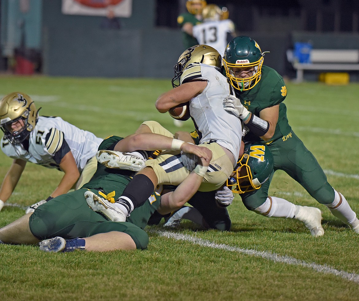 Whitefish's Ty Schwaiger assists teammates Cody Berry and Montana Cohenour on a tackle in a game against Stevensville on Thursday in Whitefish. (Whitney England/Whitefish Pilot)
