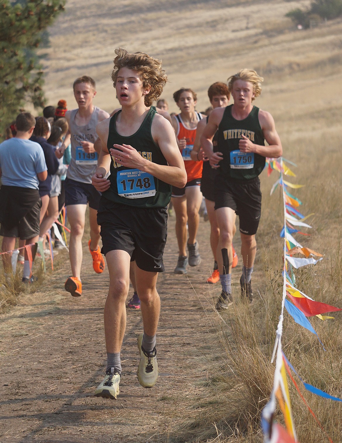 Whitefish freshman Ethan Amick runs just in front of senior Cole Cameron after cresting the hill climb on Saturday at the Mountain West Classic in Missoula. (Matt Weller photo)