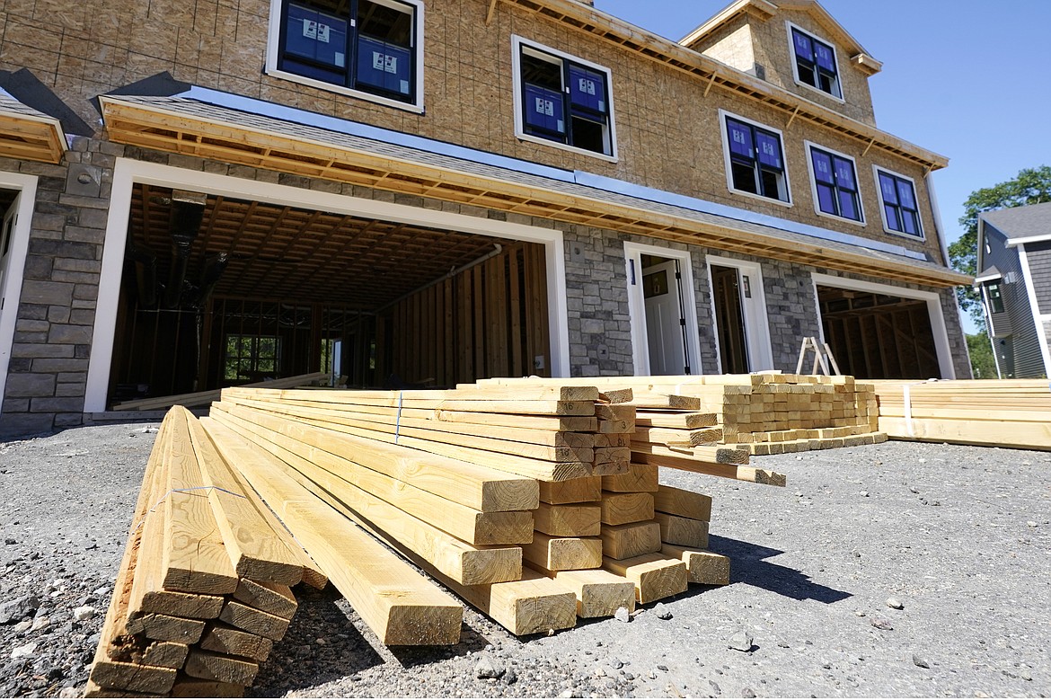 In this June 24, 2021 photo, lumber is piled at a housing construction site in Middleton, Mass.(AP Photo/Elise Amendola)