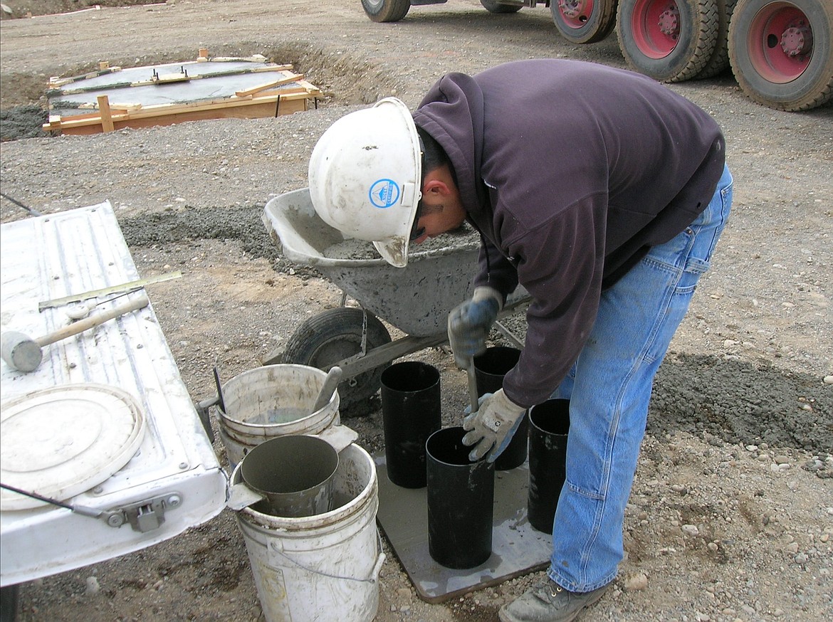 A Budinger team member collects concrete samples in order to test its strength.