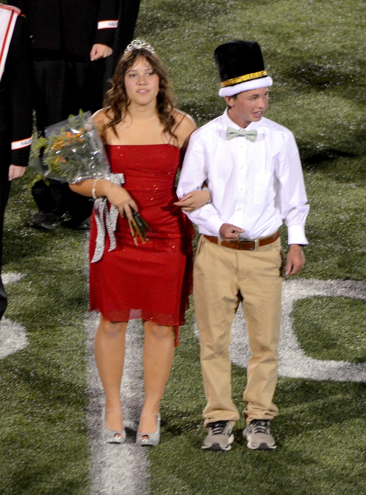 Flathead High School homecoming queen Isabella Shinn and king Peter Wilson smile at the crowd of Legends Stadium on Friday, Sept. 17, 2021, after being announced as their class's top royalty during halftime of the Braves football game against Butte High. (Tatyana Kigilyuk/Flathead Yearbook)