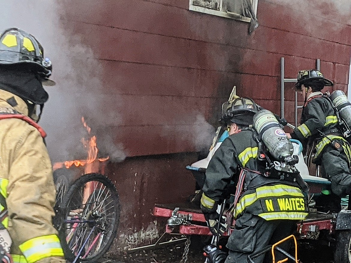 SCFD No. 1 Firefighter Dan Parrish, along with SCFD No. 2 Firefighters Nick Waites and Kyan "Pepper" Zimmerman, observe the flames erupting from the home's basement. The fire started with the home's basement dryer and expanded from there.