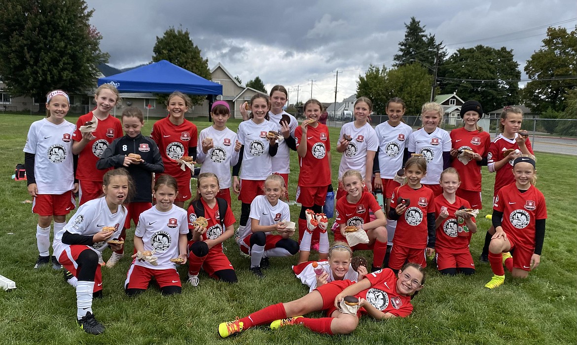 Courtesy photo
The Thorns North FC 2011 Girls Yellow soccer team competed in the Kochava Pend Oreille Cup soccer tournament in Sandpoint on Sept. 17-19. On Saturday, Kylie Lorona scored the lone Thorns goal against the Sandpoint Strikers in a 2-1 loss. The Thorns then beat FC Spokane 2012 3-2 with Brightyn Gatten scoring two goals and Olivia Nusser scoring one goal. On Sunday, the Thorns played their sister team, the Thorns North FC 2011 Girls Green team, and lost 1-0. Pictured are the Thorns North FC 2011 Girls Yellow and Green teams sharing a post-game treat. In the front from left are Brightyn Gatten and Ella Linder; front row from left, Sophia Harrington, Victoire James, Avery Thompson, Evelyn Haycraft, Payton Brennan, Gracie McVey, Olivia Hynes and Riley Greene; and back row from left, Aubrey Sargent, Zoey Lemmon, Mackenzie Dolan, Emilia Meyer, Victoria Howard, Kylie Lorona, Olivia Nusser, Sierra Jones, Emily Hackett, Vivian Hartzell, Eloise Elgee, Amelia Liddiard and Ava Claire Langer.