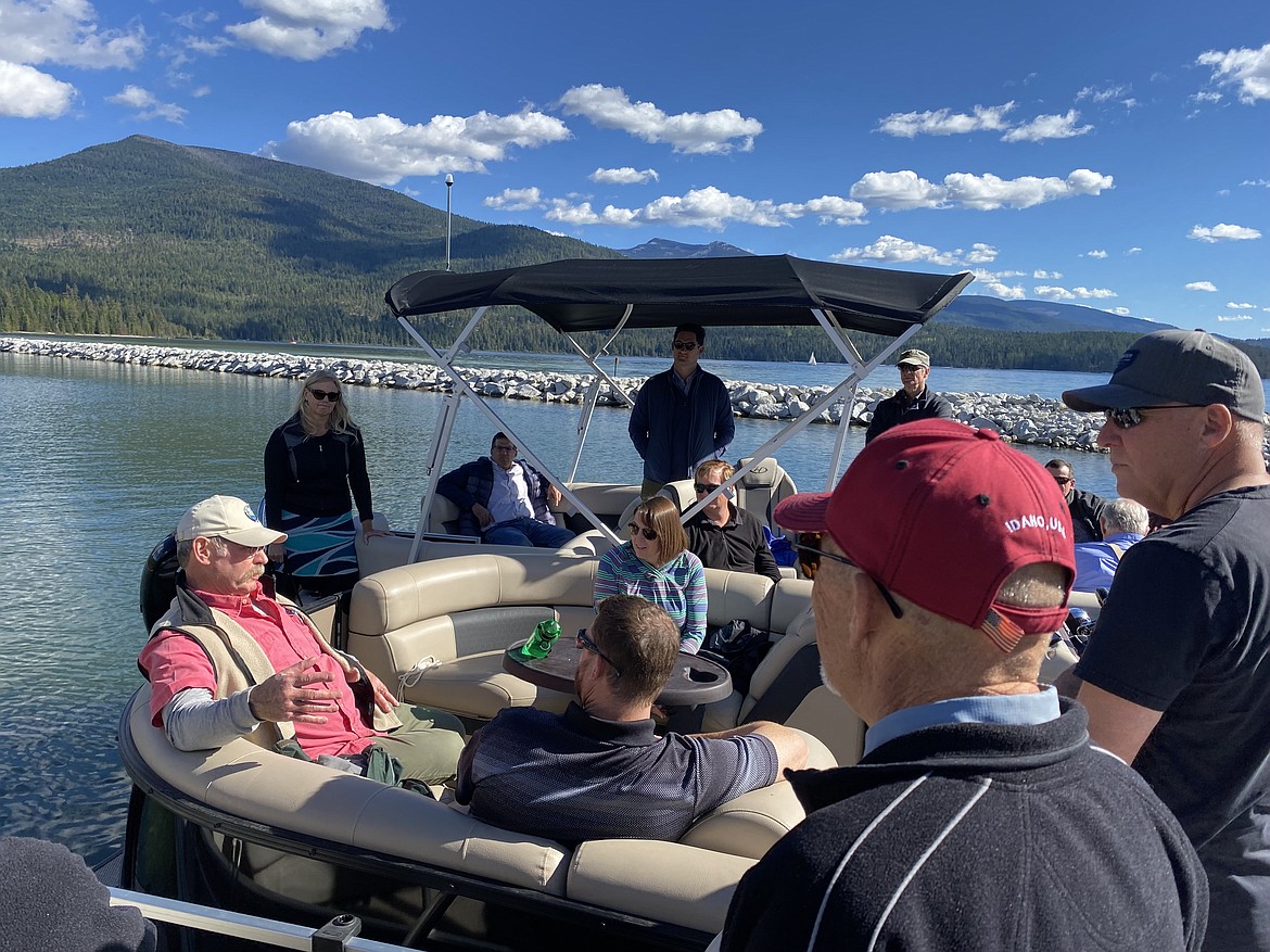 Steve Klatt, left, talks about the unique partnership between the state, the Legislature, the Idaho governor's office, Bonner County and Priest Lake residents to make the $5 million Priest Lake Water Management Project happen. State Sen. Steve Vick is at right with the red ball cap, next to Randy Ramey, Thorofare resident. Jo Ann Cole-Hansen, Idaho Water Resource Board member from Lewiston, is sitting across from Klatt.